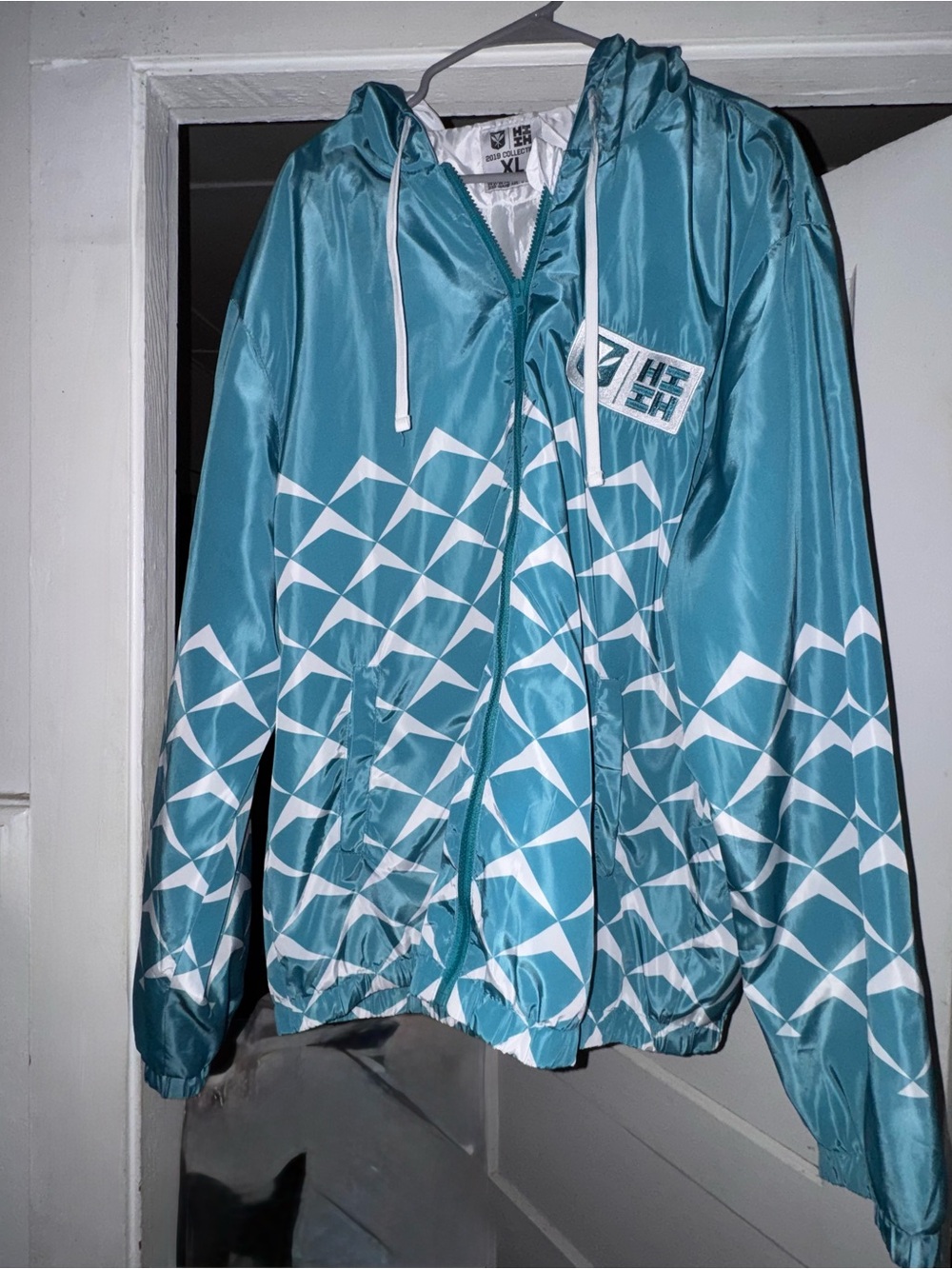 Hawaii’s Finest teal and white wind breaker